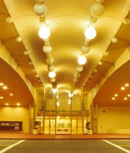 Exterior of Civic Center showing entrance and lighted street beneath archway.