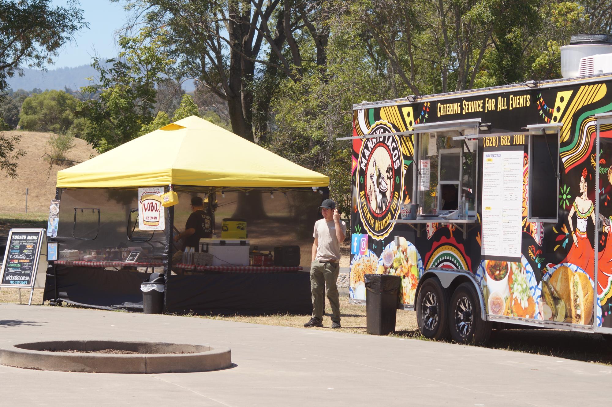 Food truck and booth sit next to one another.