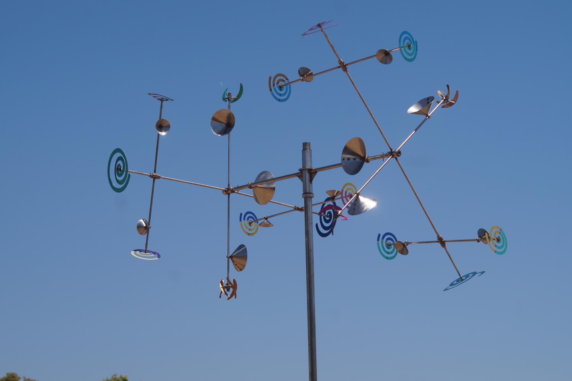 a large art installation / structure mobile with spiral designs on it