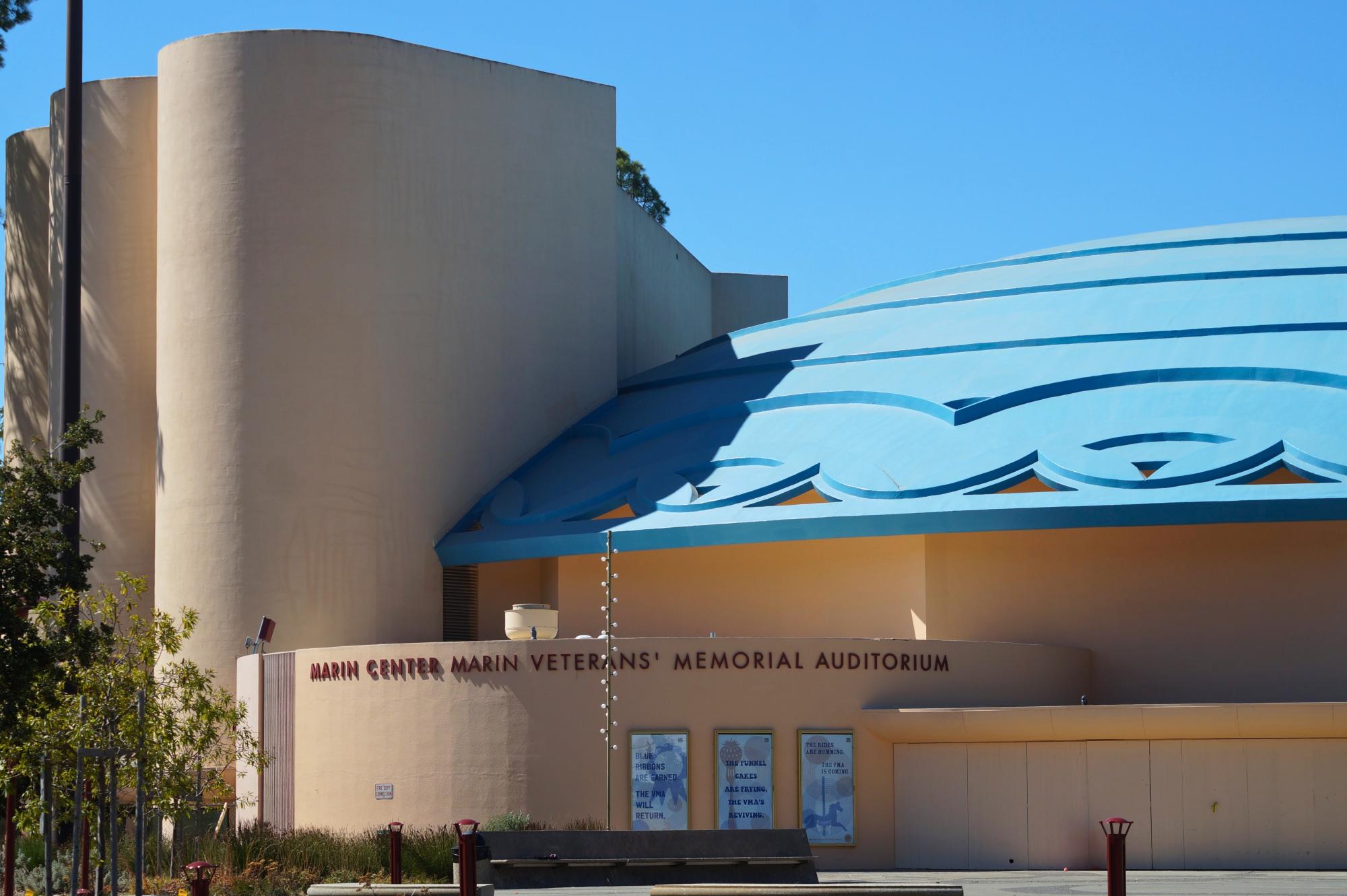 A tan building with a blue domed roof