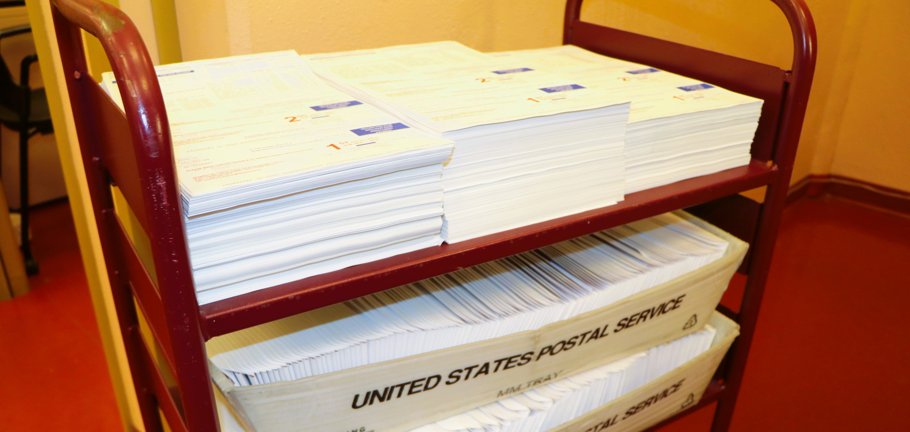 A closeup view of a stack of property tax bills in envelopes that have not been mailed.