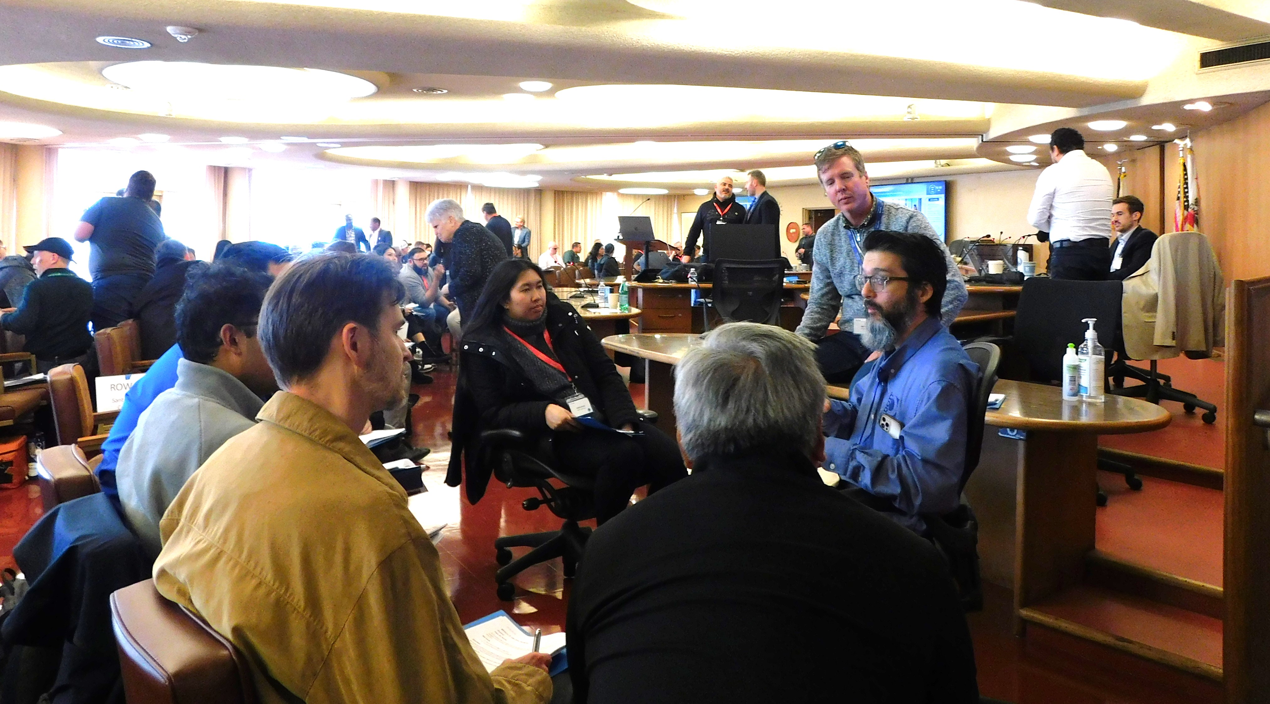 Dozens of people meet in the Marin County Board of Supervisors chamber and talk about cybersecurity.
