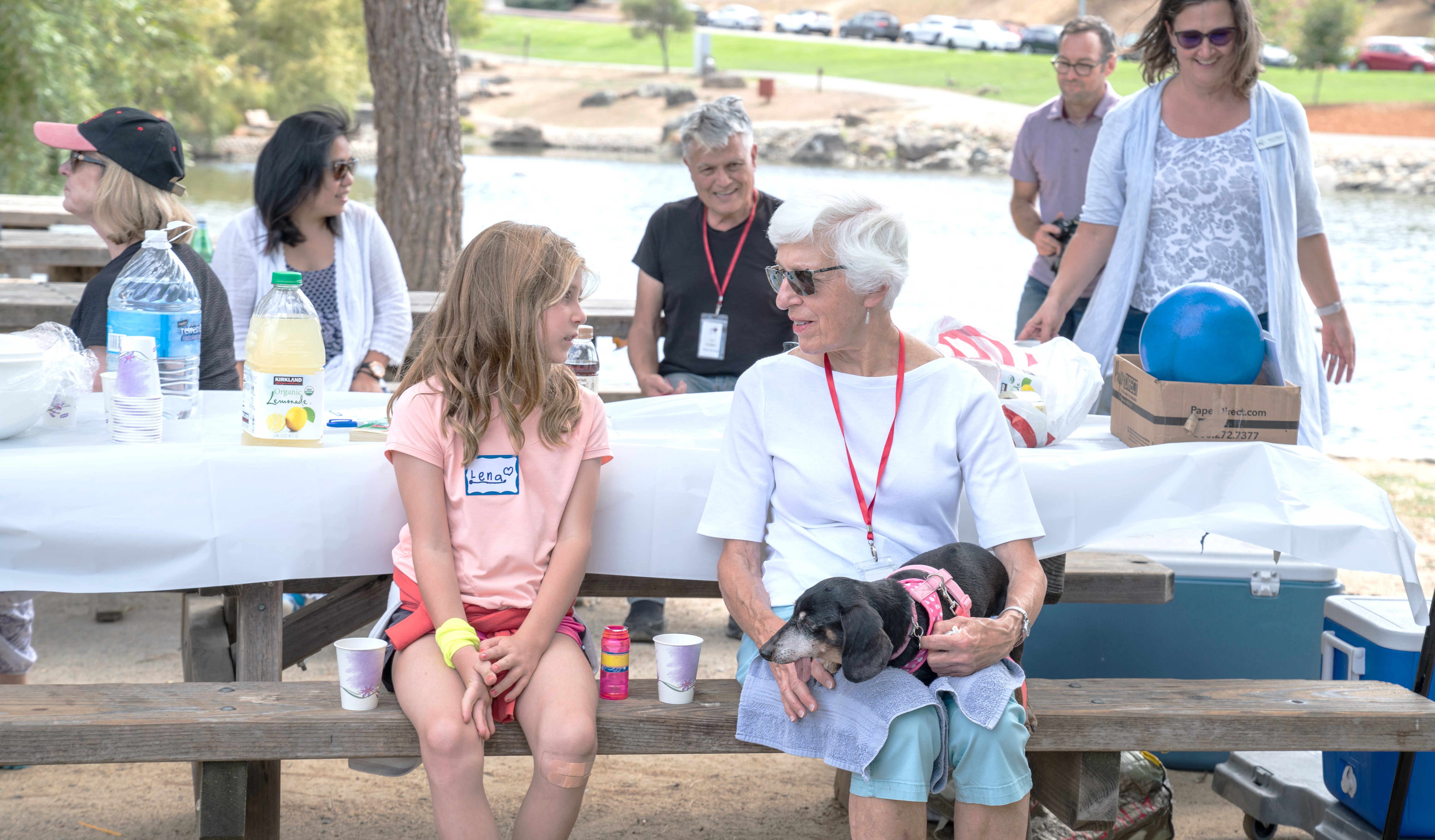 An older woman speaks with a young girl during an environmental education outing. 