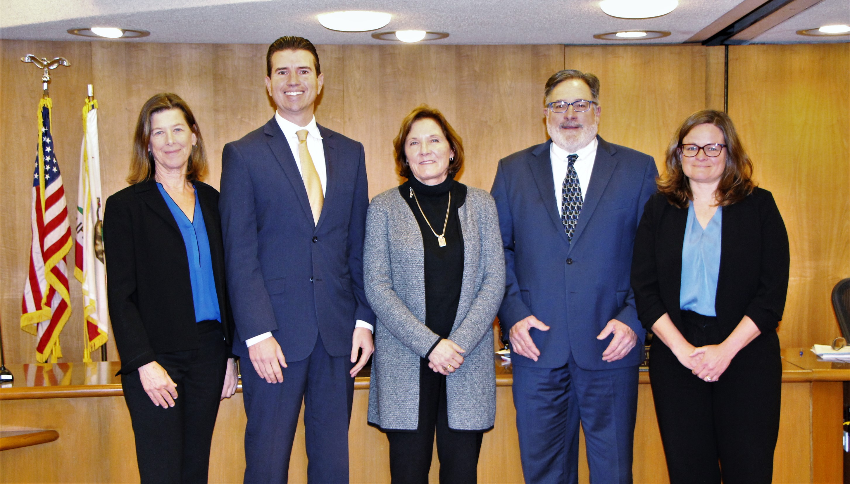 Board of Supervisors members stand together