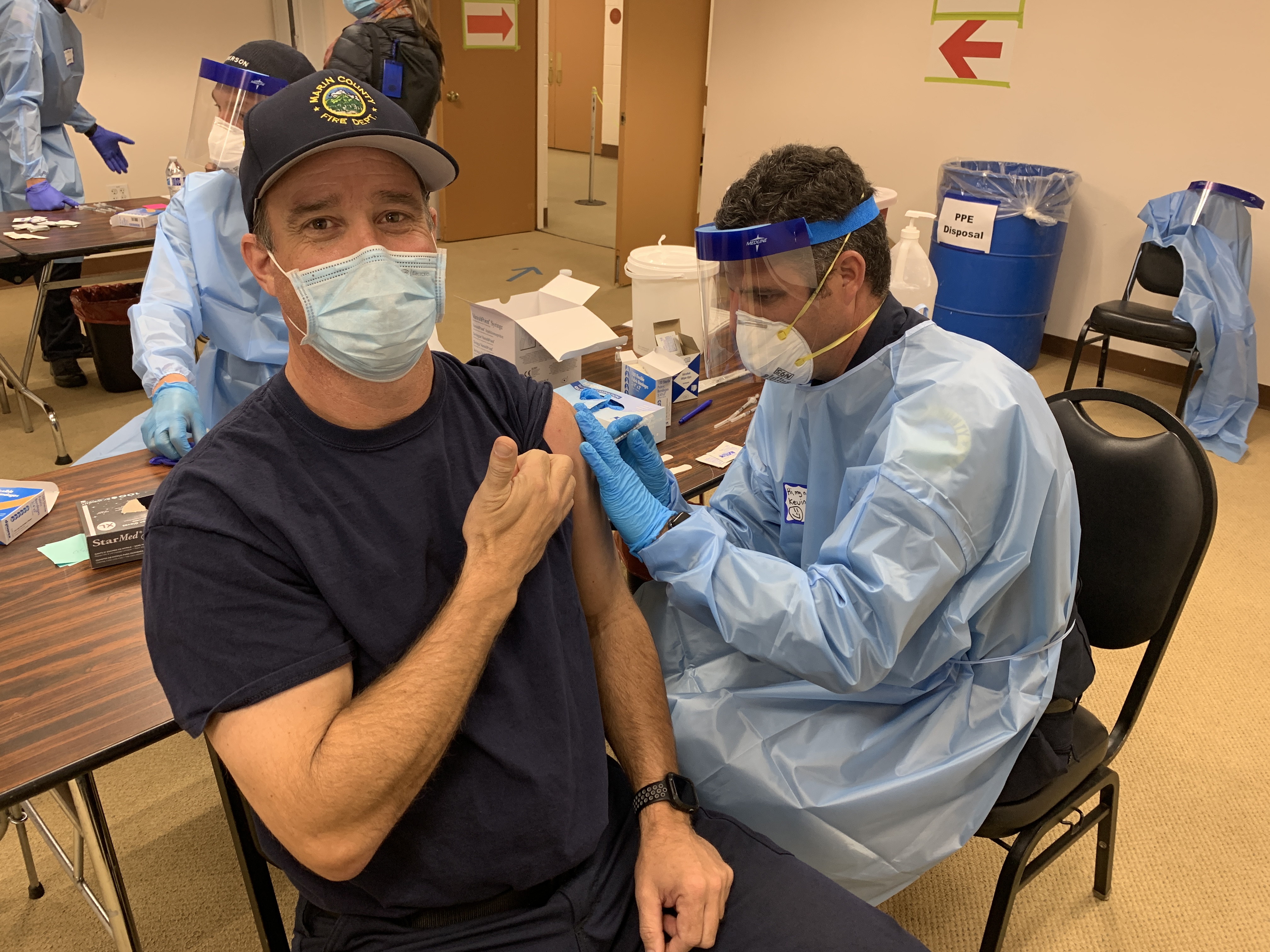 A firefighter receives a COVID-19 vaccine.