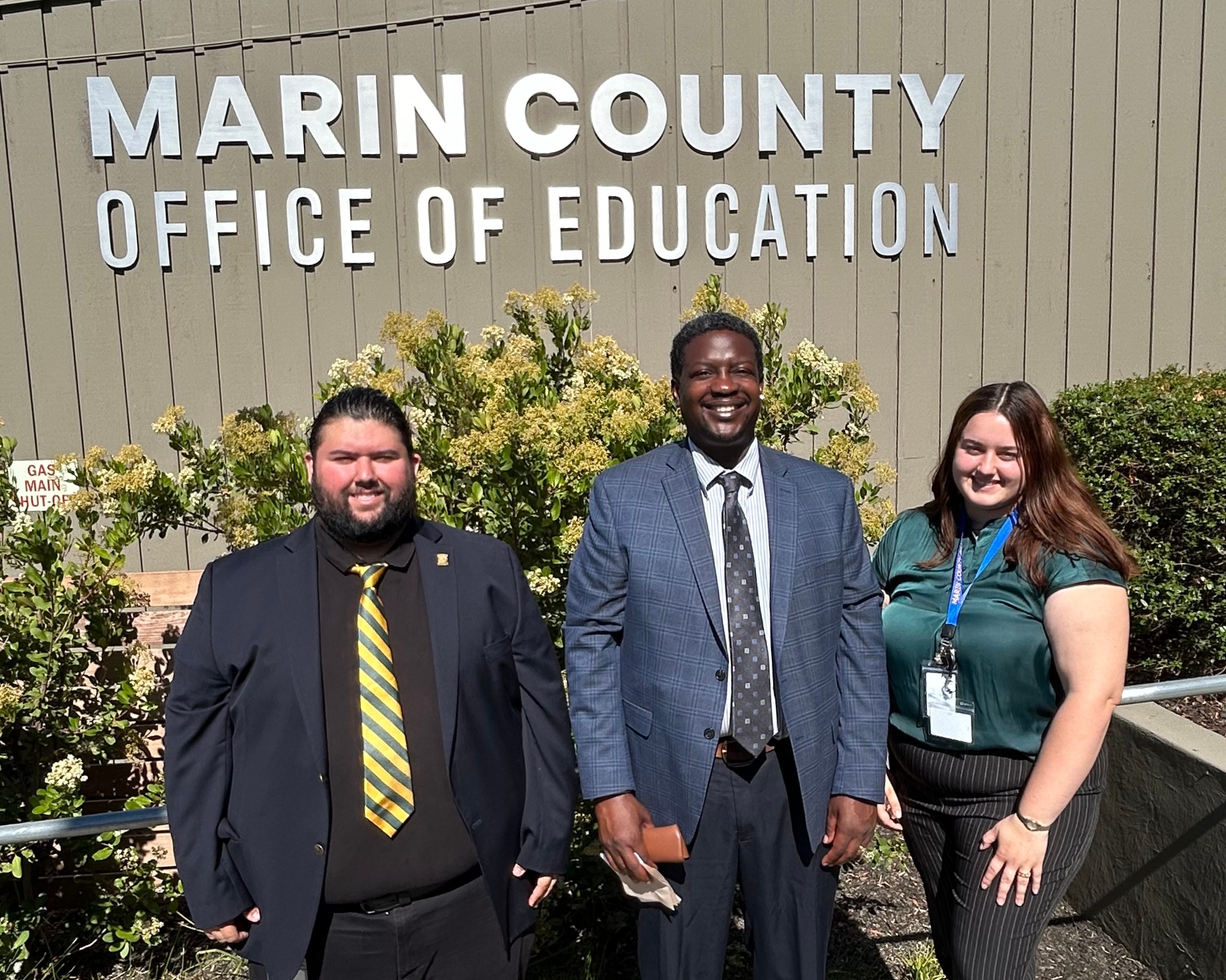 Probation Chief Marlon Washington poses with two workers.