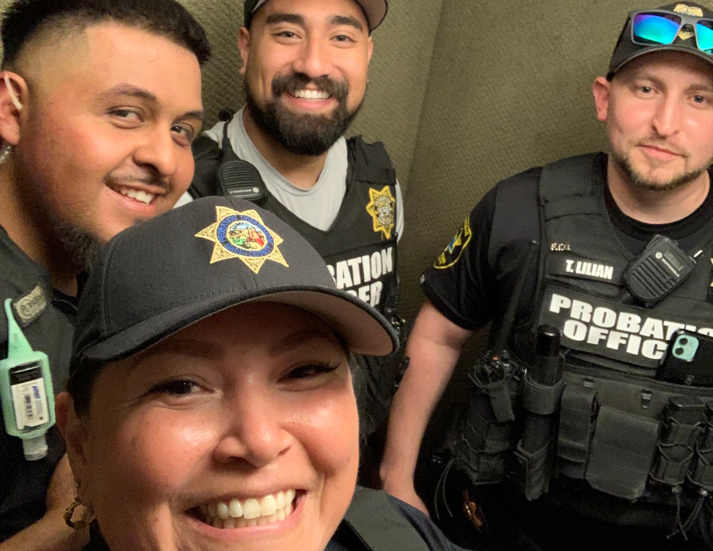 Four probation officers smile.
