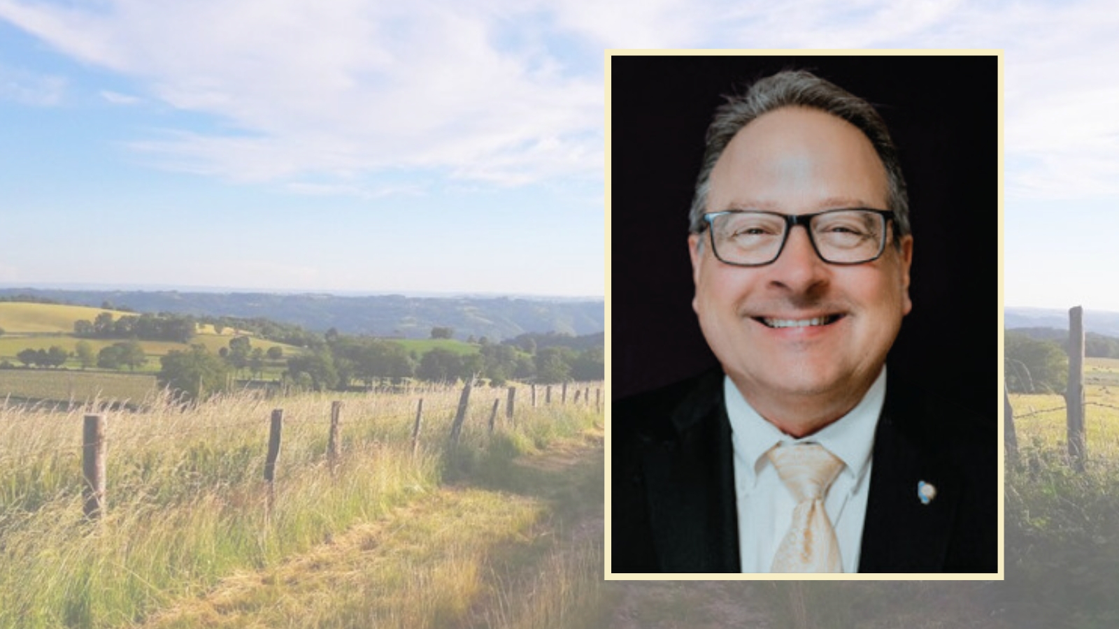 Headshot of Joe Deviney with a background showing a Marin County pasture.