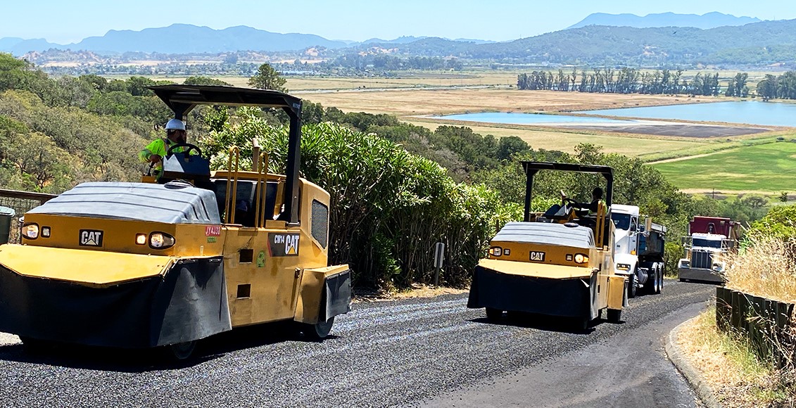 Heavy equipment is used to repave a road.