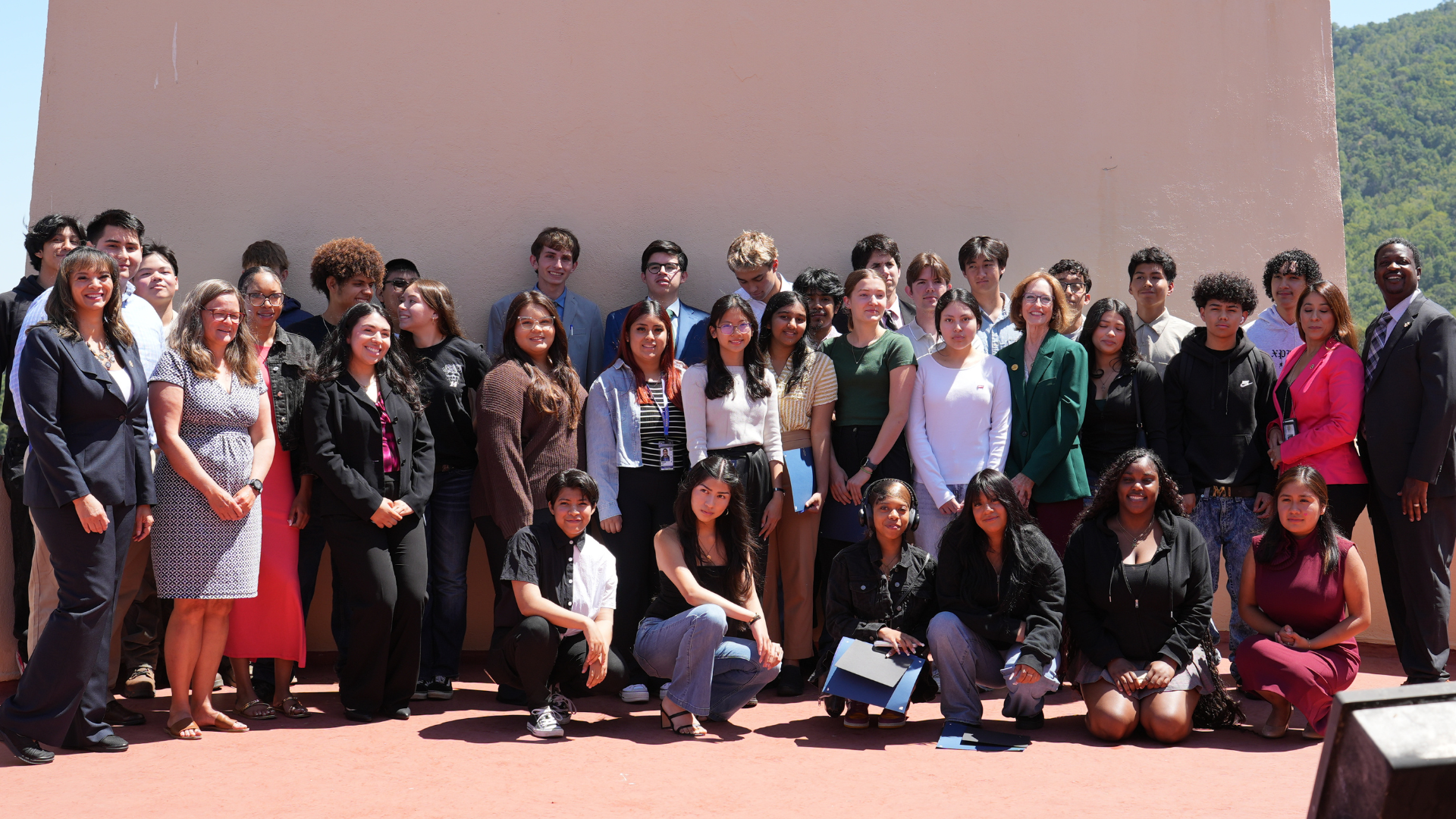 The 2024 Class of Career Explorers stand with various County staff members. 