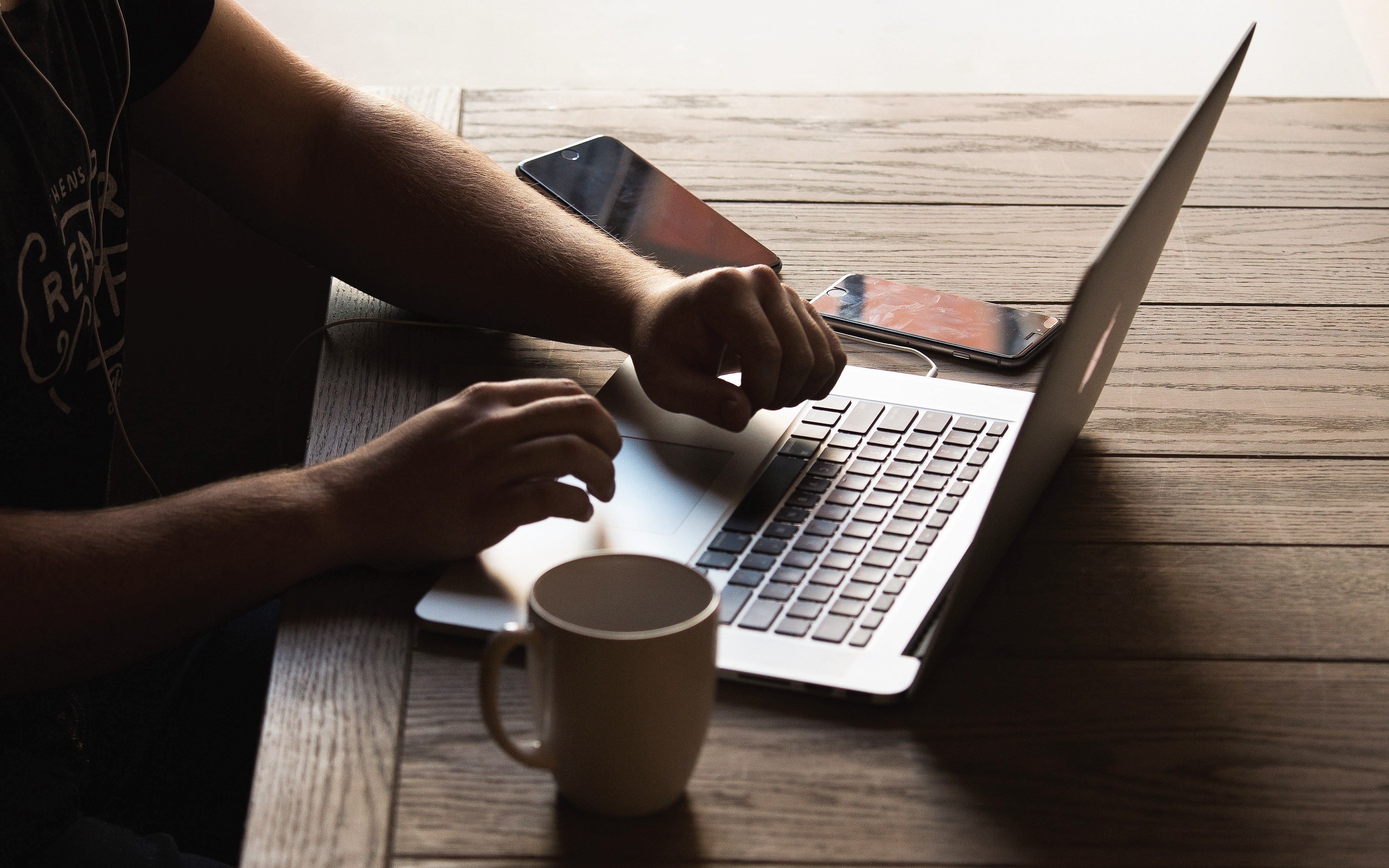A person's hands on a laptop computer.