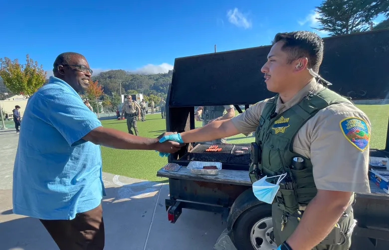 Pastor Floyd and MC Sheriff shaking hands