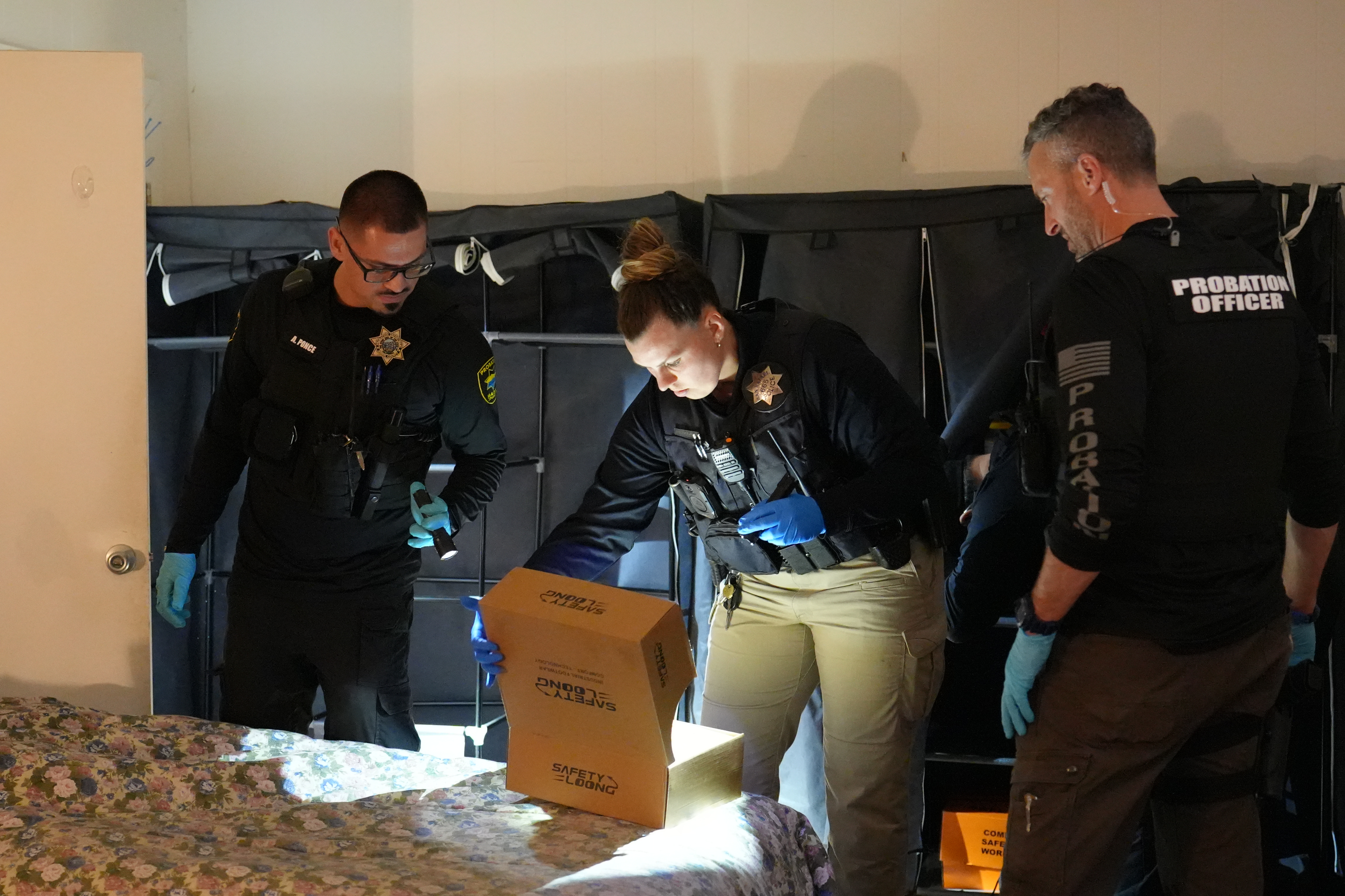 Law enforcement officers check a probationer's residence.