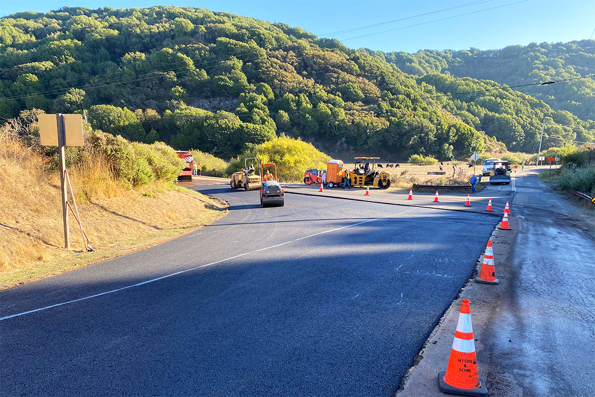 A crew repaves a road in rural West Marin.