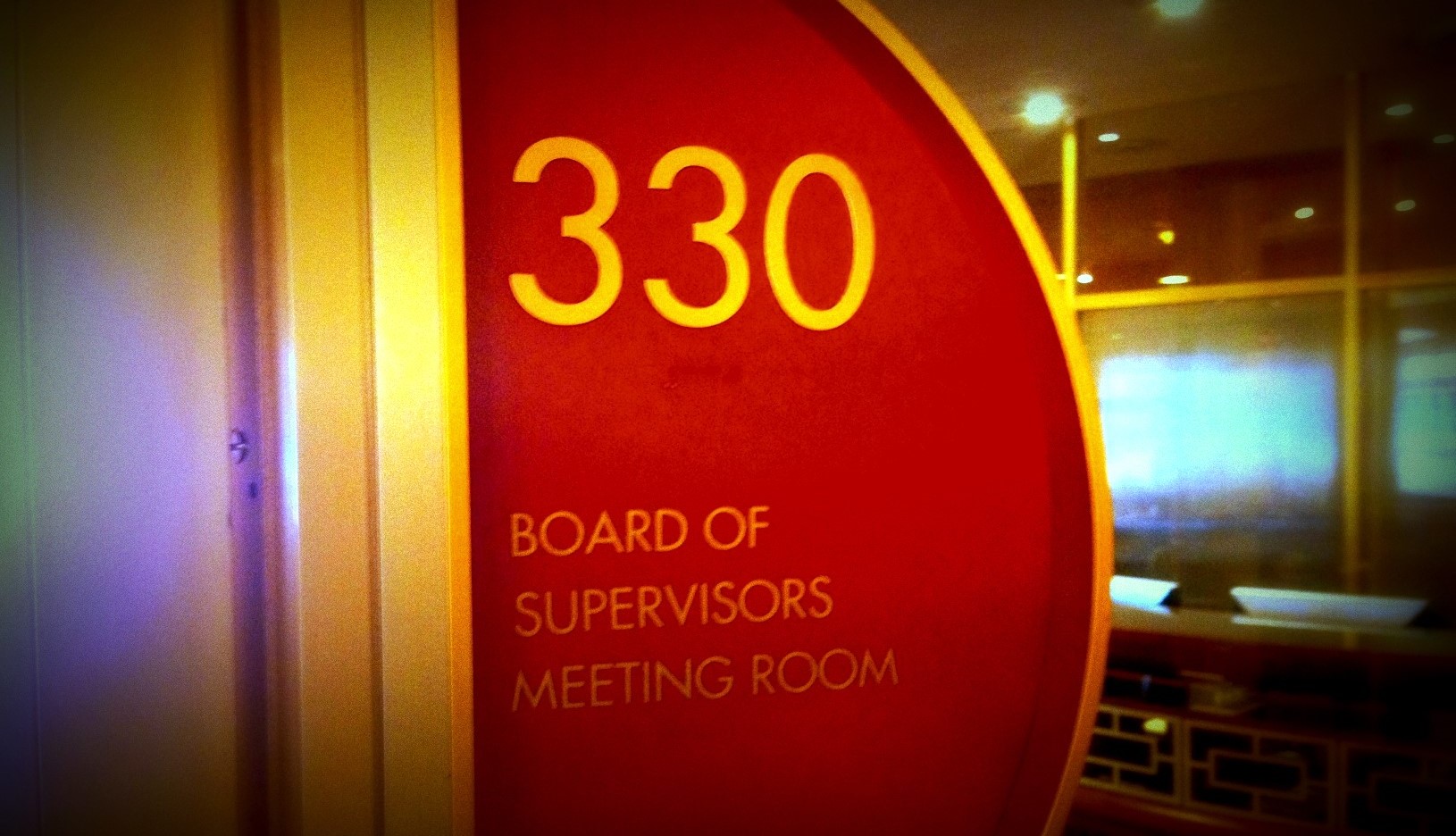 A sign outside of the Board of Supervisors chamber