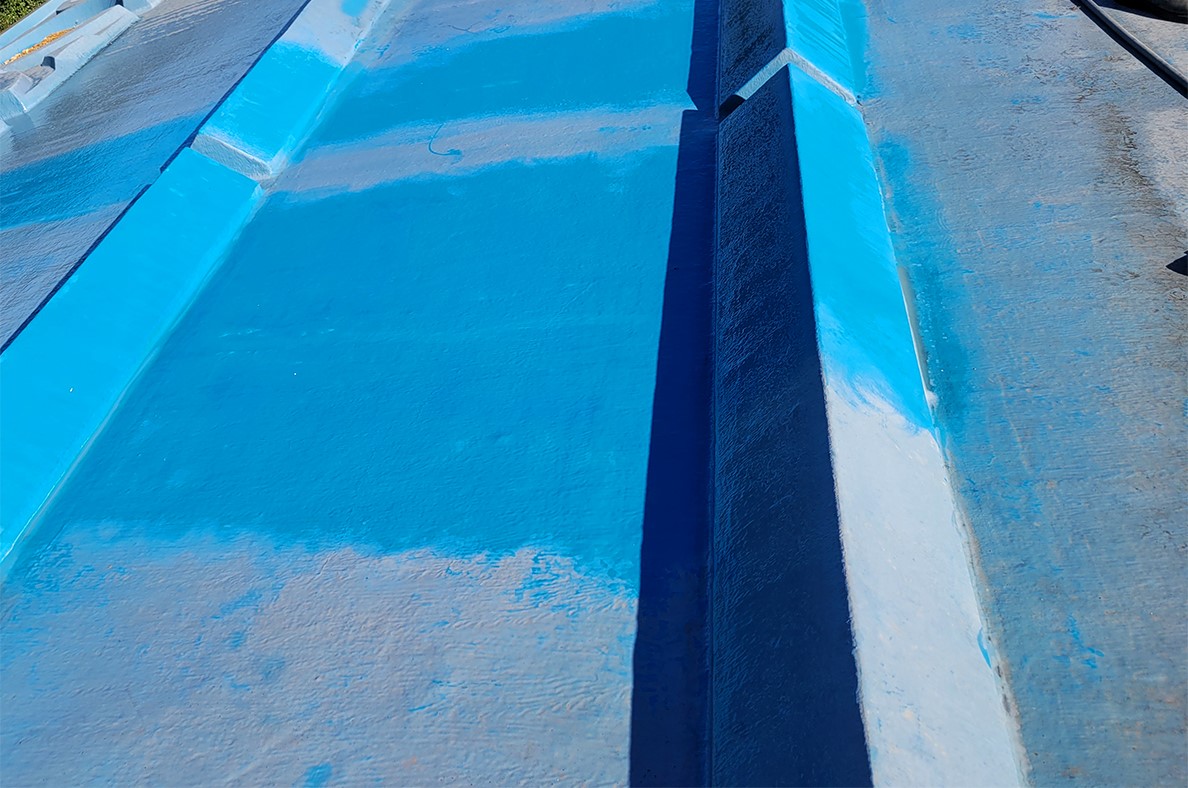 A closeup view of the old paint and cleaned paint on the roof.