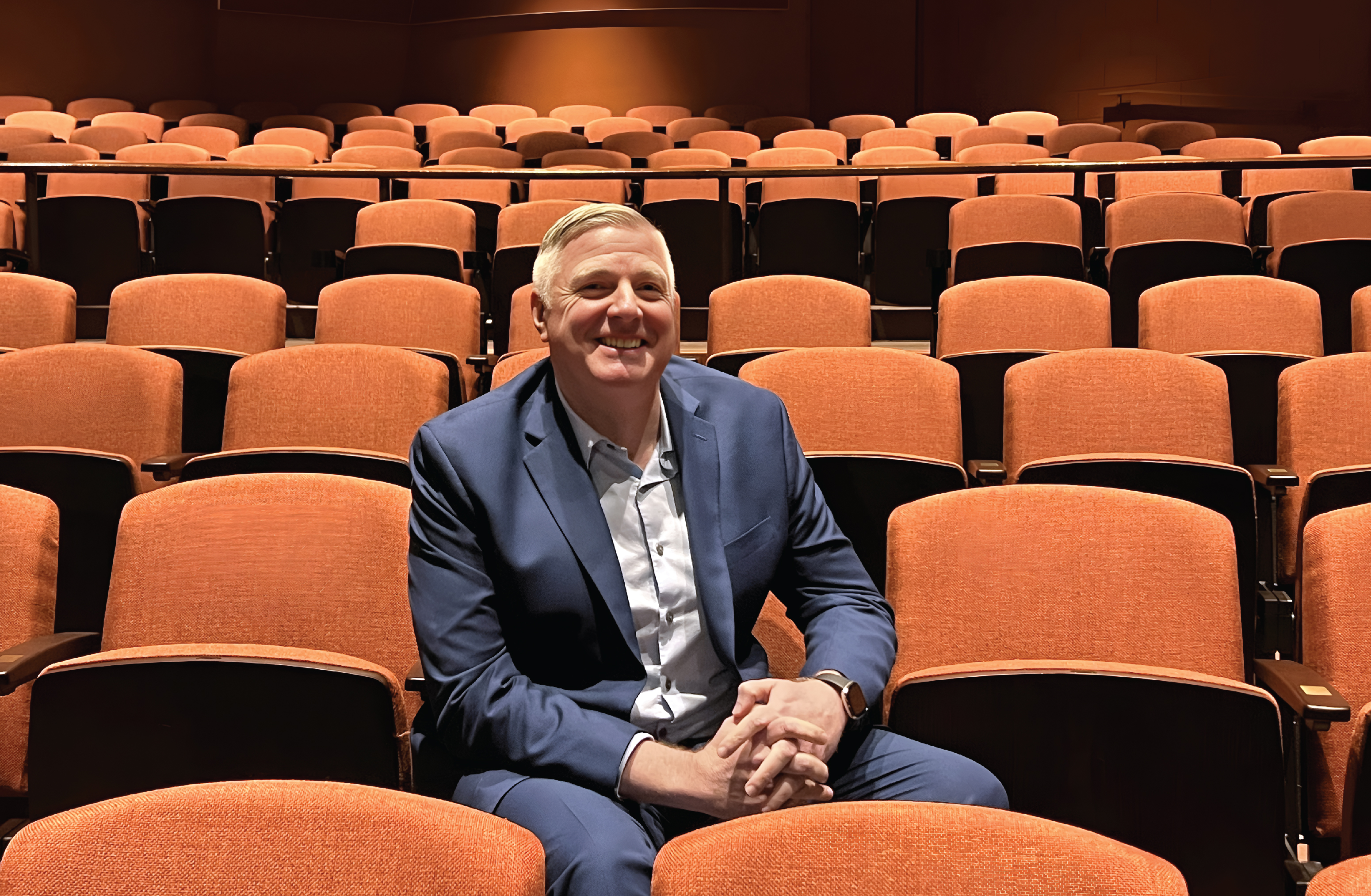 Portrait of Steve Dow sitting in a seat at Showcase Theater.