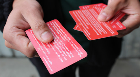 person holding know your rights cards