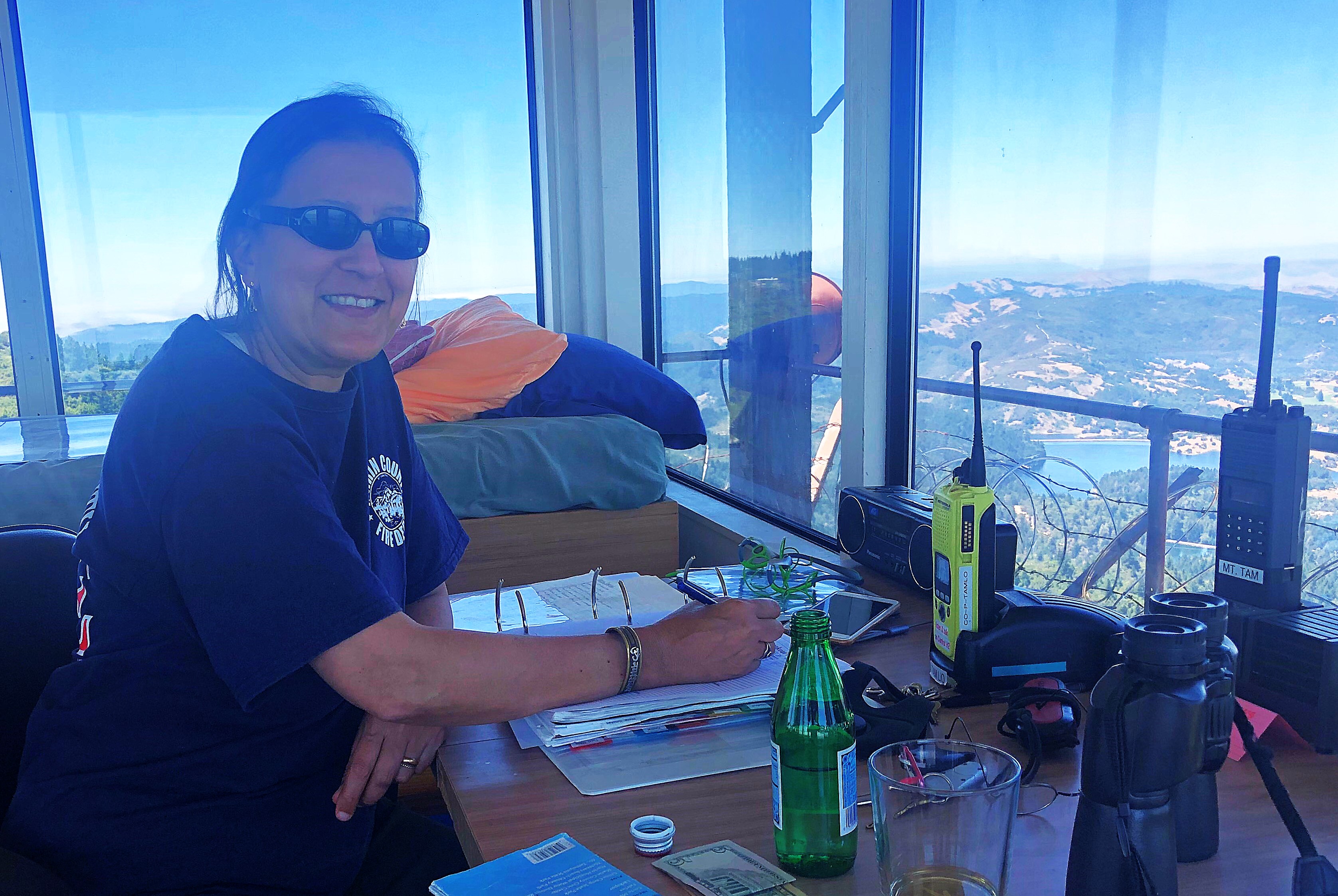 Sunita Ellenby sits at her fire lookout station watching for signs of wildfire.