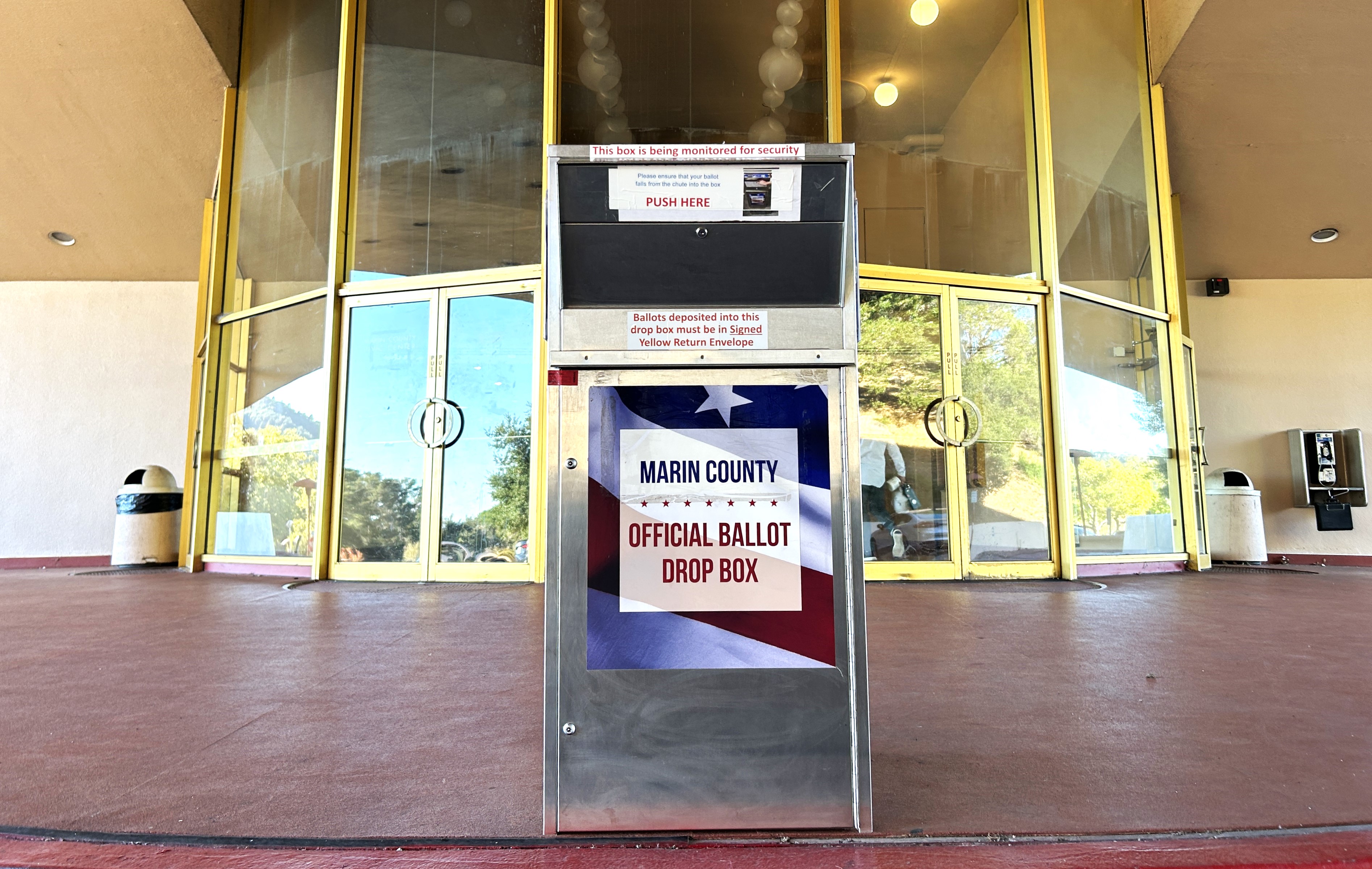 An official ballot drop box is shown at the middle archway at the Civic Center.
