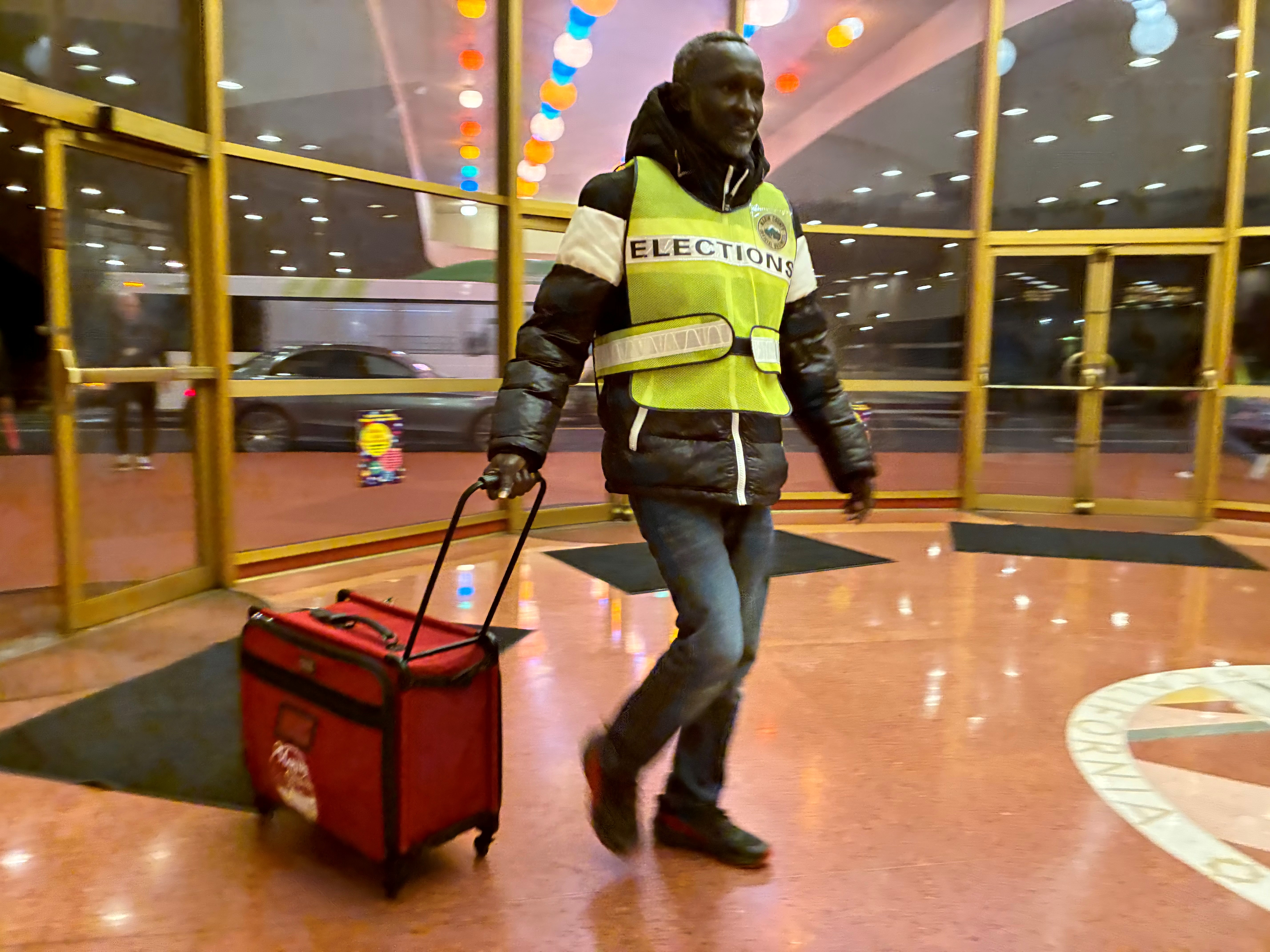 Elections Department team member Kunta Kimbe arrives at the Marin County Civic Center on Election Night, delivering secured ballots from a vote center for tabulation. 