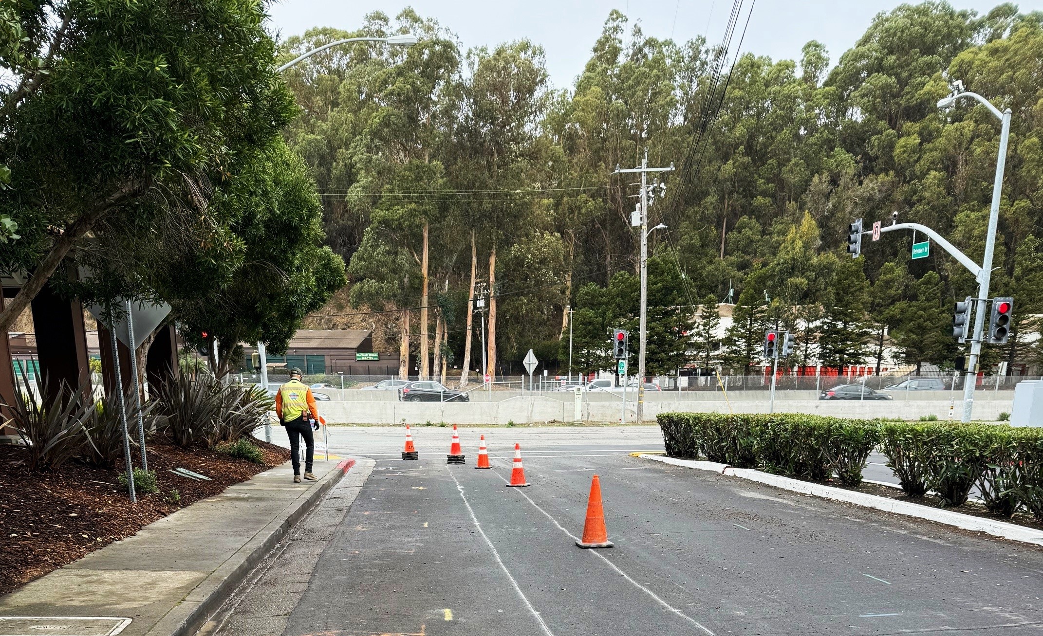 A construction worker in a hardhat walks near a the underground work zone.