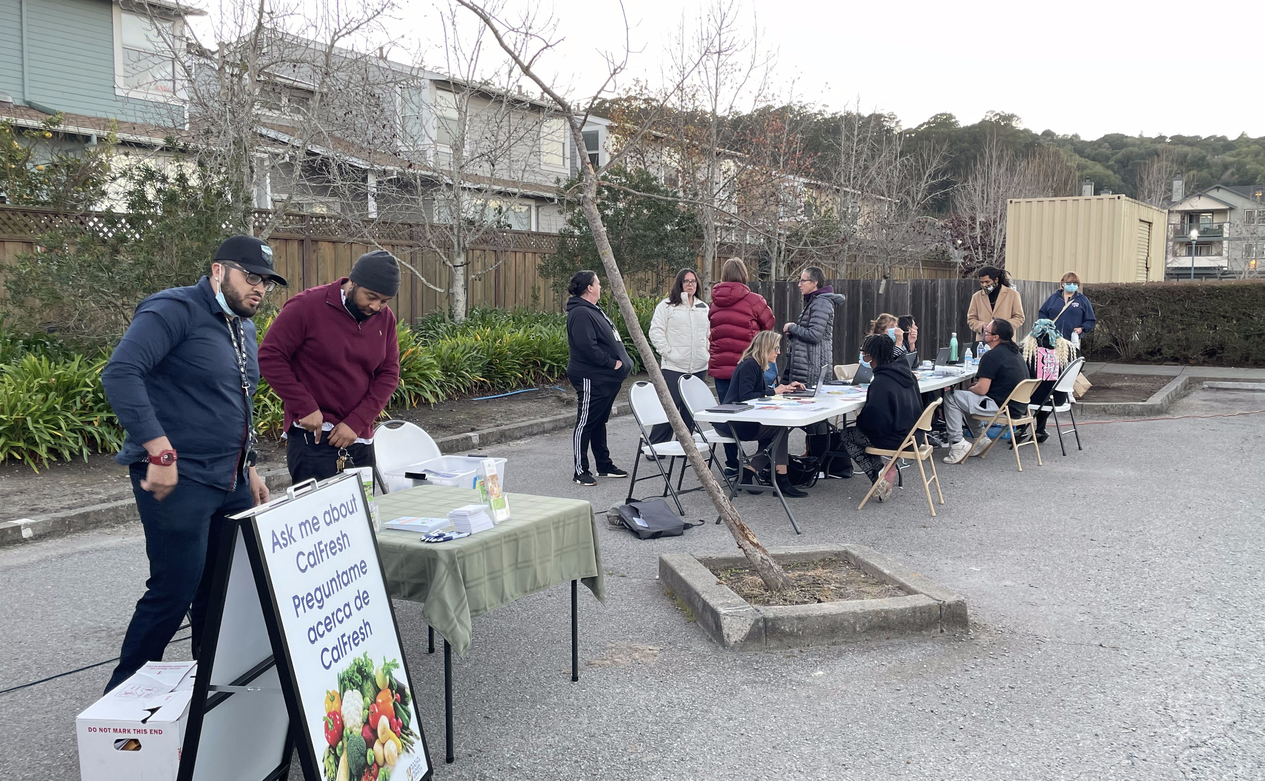 About 10 people set up a Clean Slate event at tables.