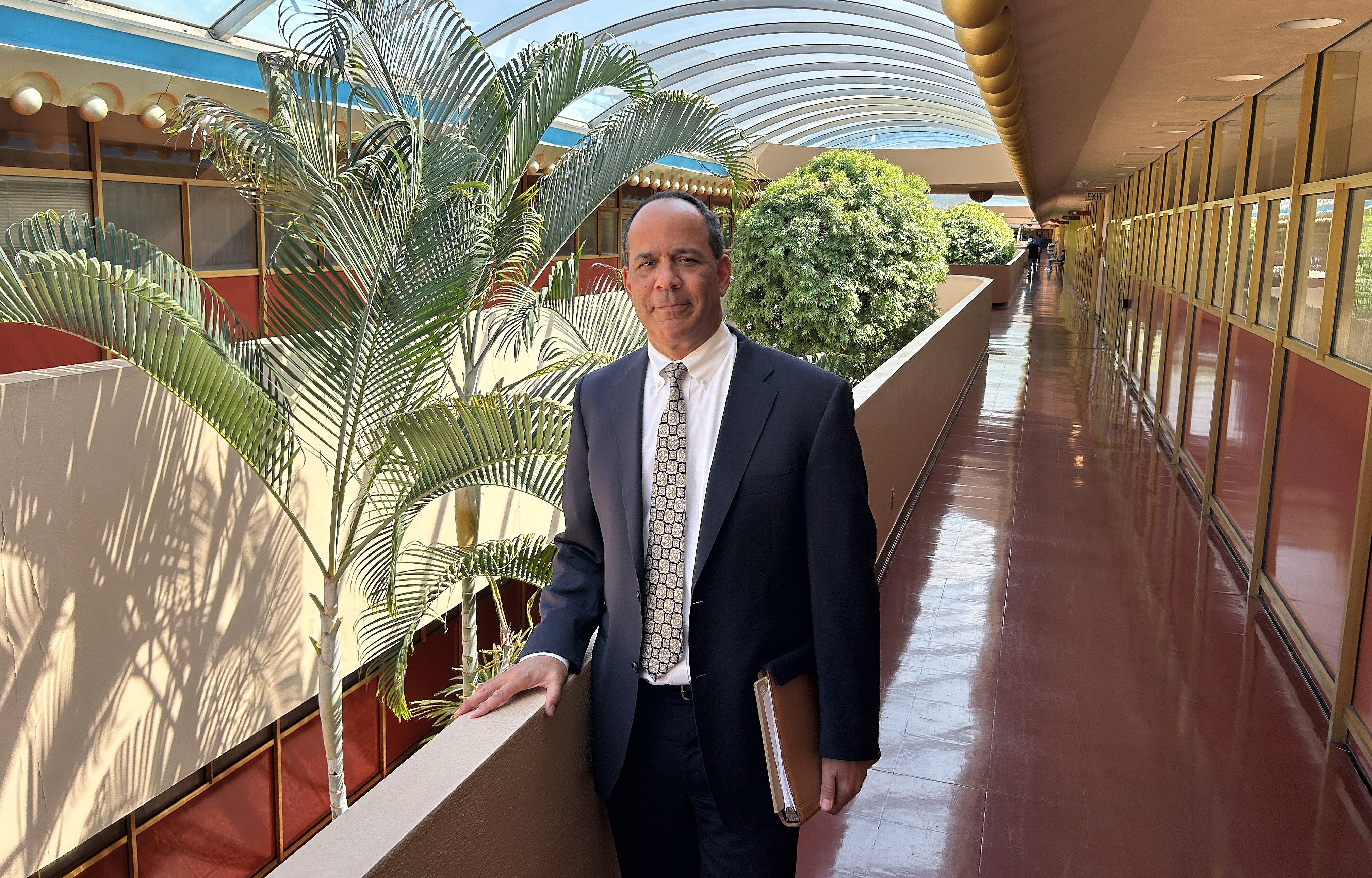 Brian Washington poses for a portrait in the Civic Center hallway near his office.