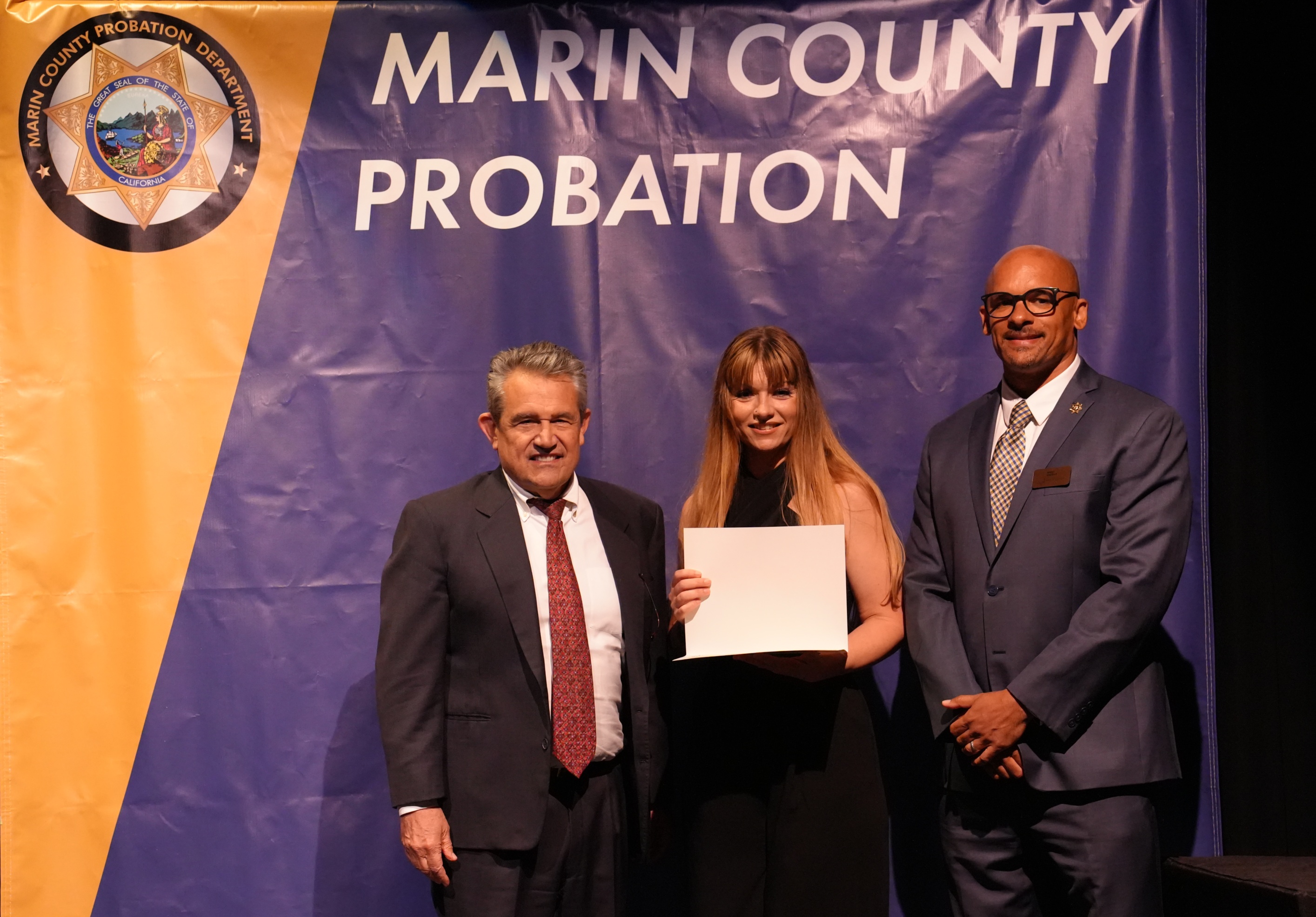 Honoree Mollie Banducci (center) is flanked by Judge Stephen Freccero and Probation Director Terry Wright during the Wall of Change ceremony.