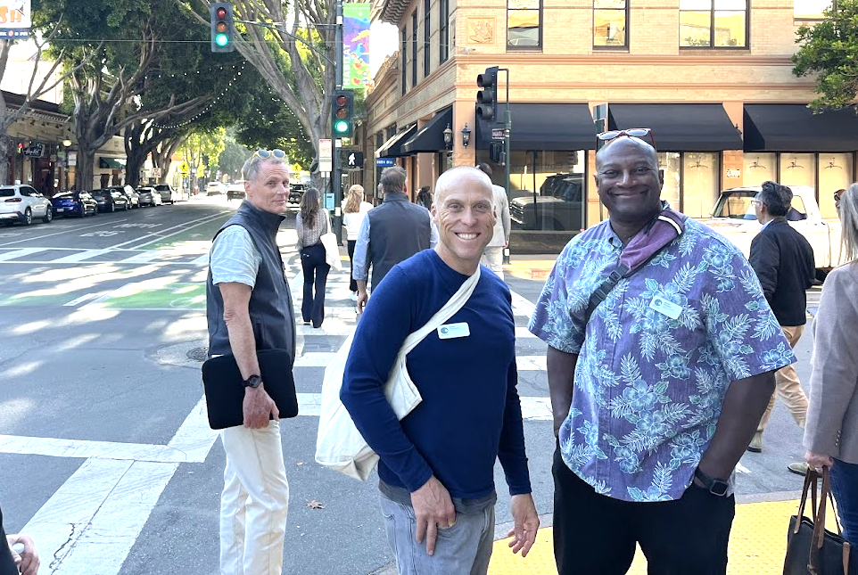 County Executive Derek Johnson and Supervisor Brian Colbert smile on a downtown street corner in San Luis Obispo.
