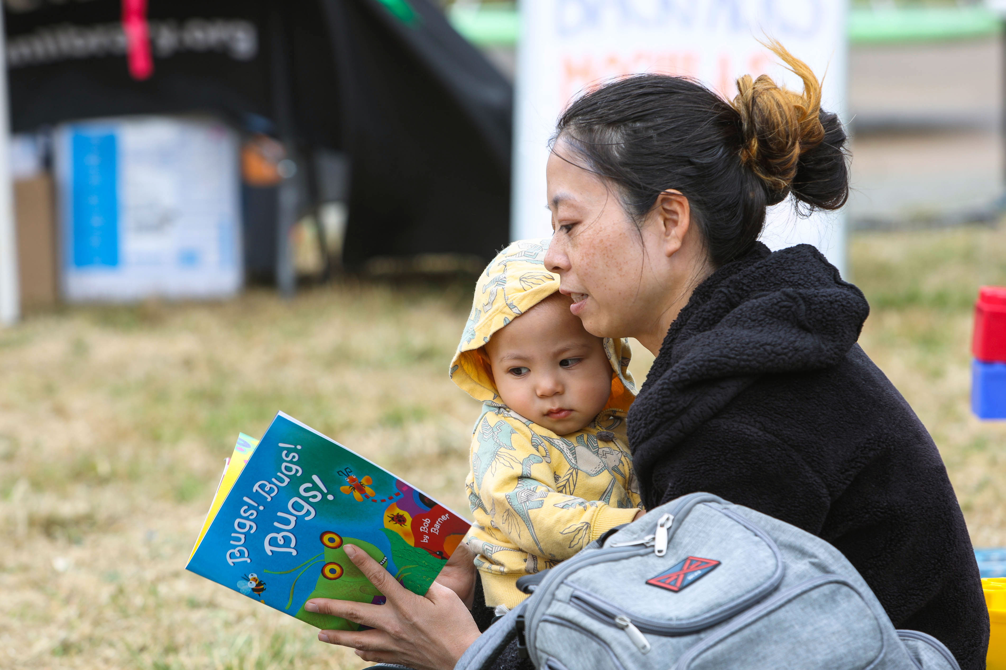 A young mother and child begin their literacy journey together, sharing the joy of reading with a free book.