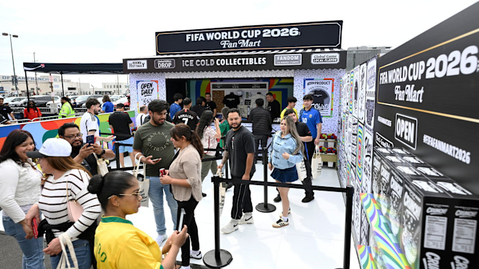 People standing in line to view the FIFA World Cup trophy.