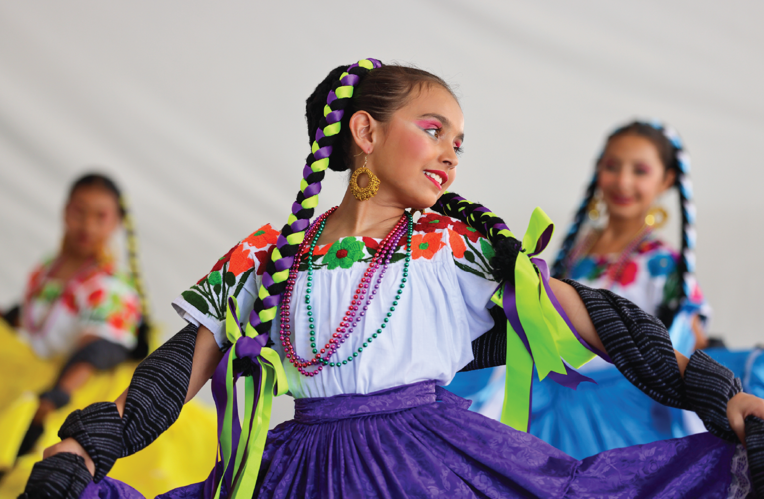 A girl is dancing and twirling her skirt.