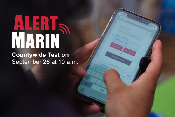 A person's hand holds a smartphone and the words AlertMarin are promoted.