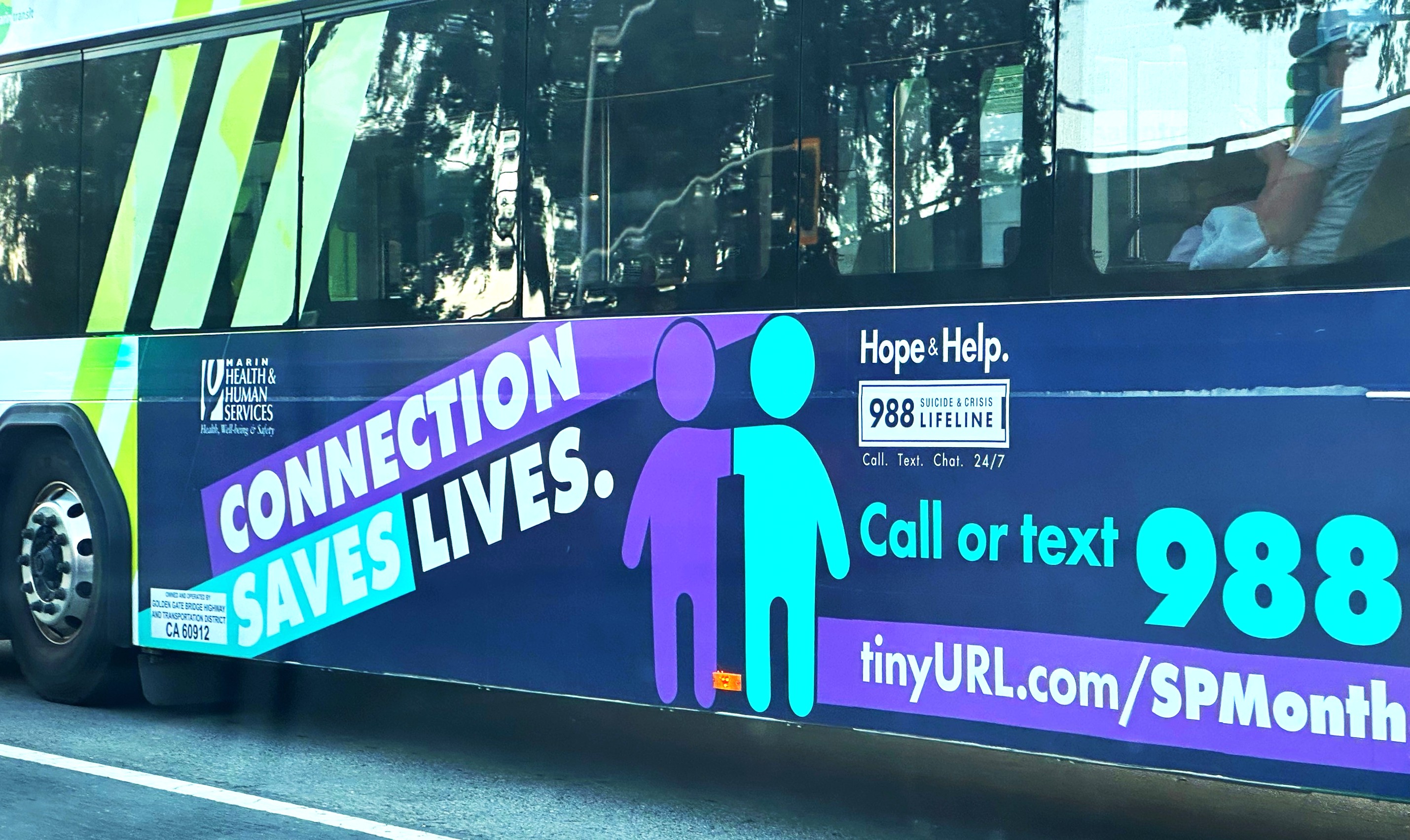 A bus advertisement promose the Suicide Prevention phone line 988.