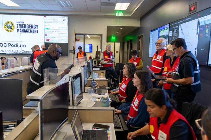 A bunch of people participate in an emergency training in the operations center.