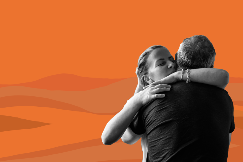 Artistic image shows a woman hugging a man in an emotional moment.