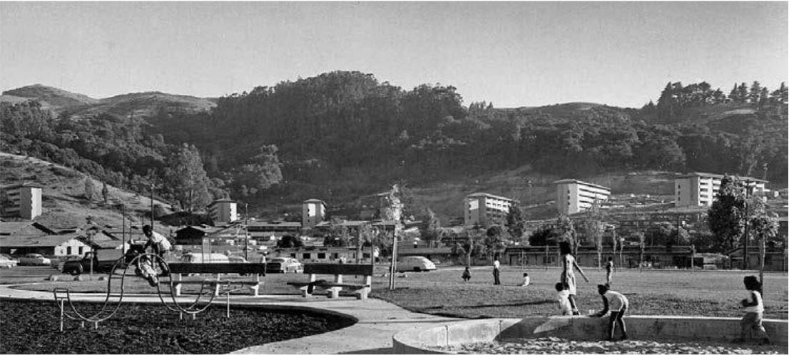 Historic photo of children playing with Golden Gate Village in the background.