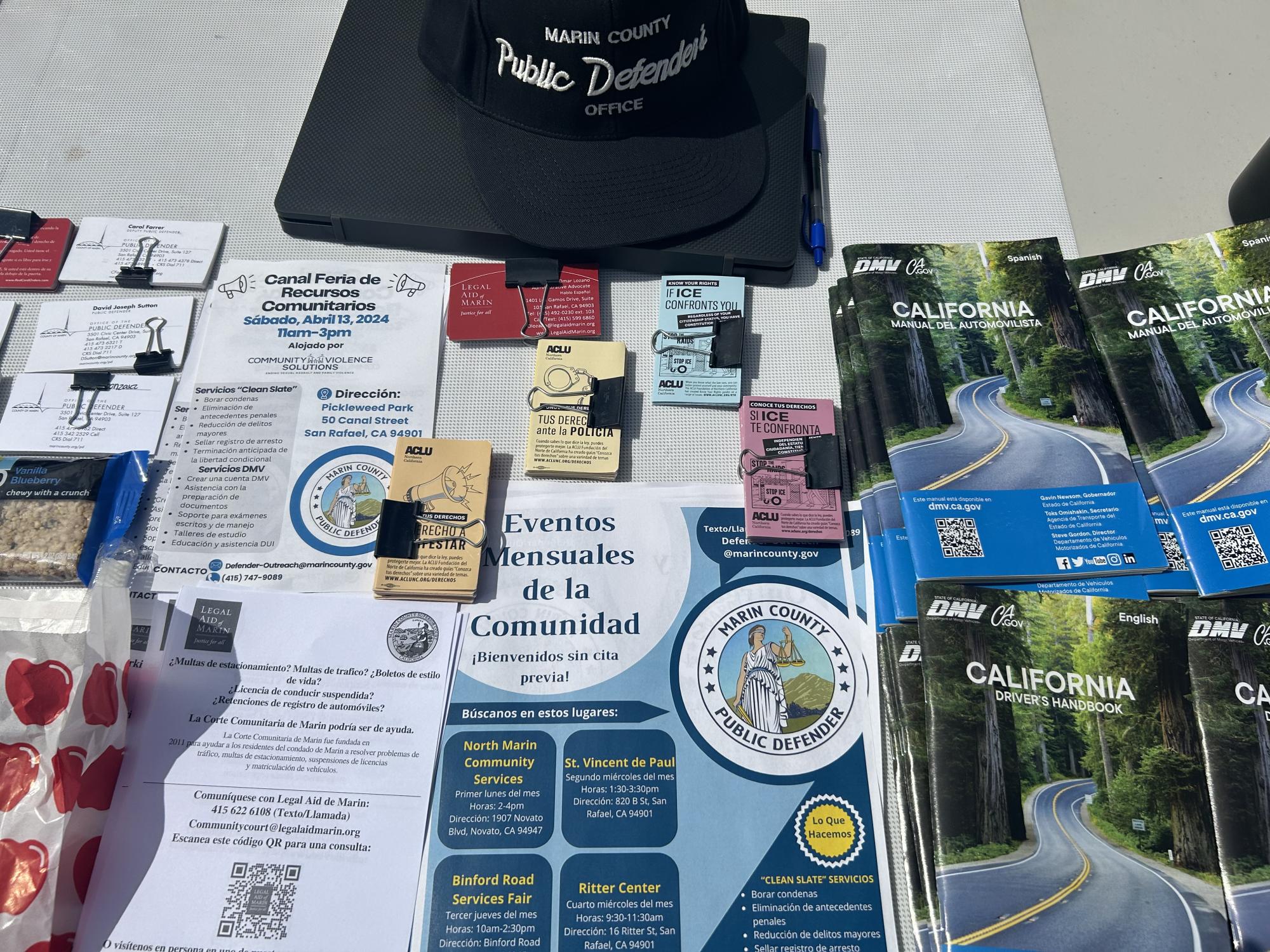 Flyers, cards, and resources provided at outreach tabling events.
