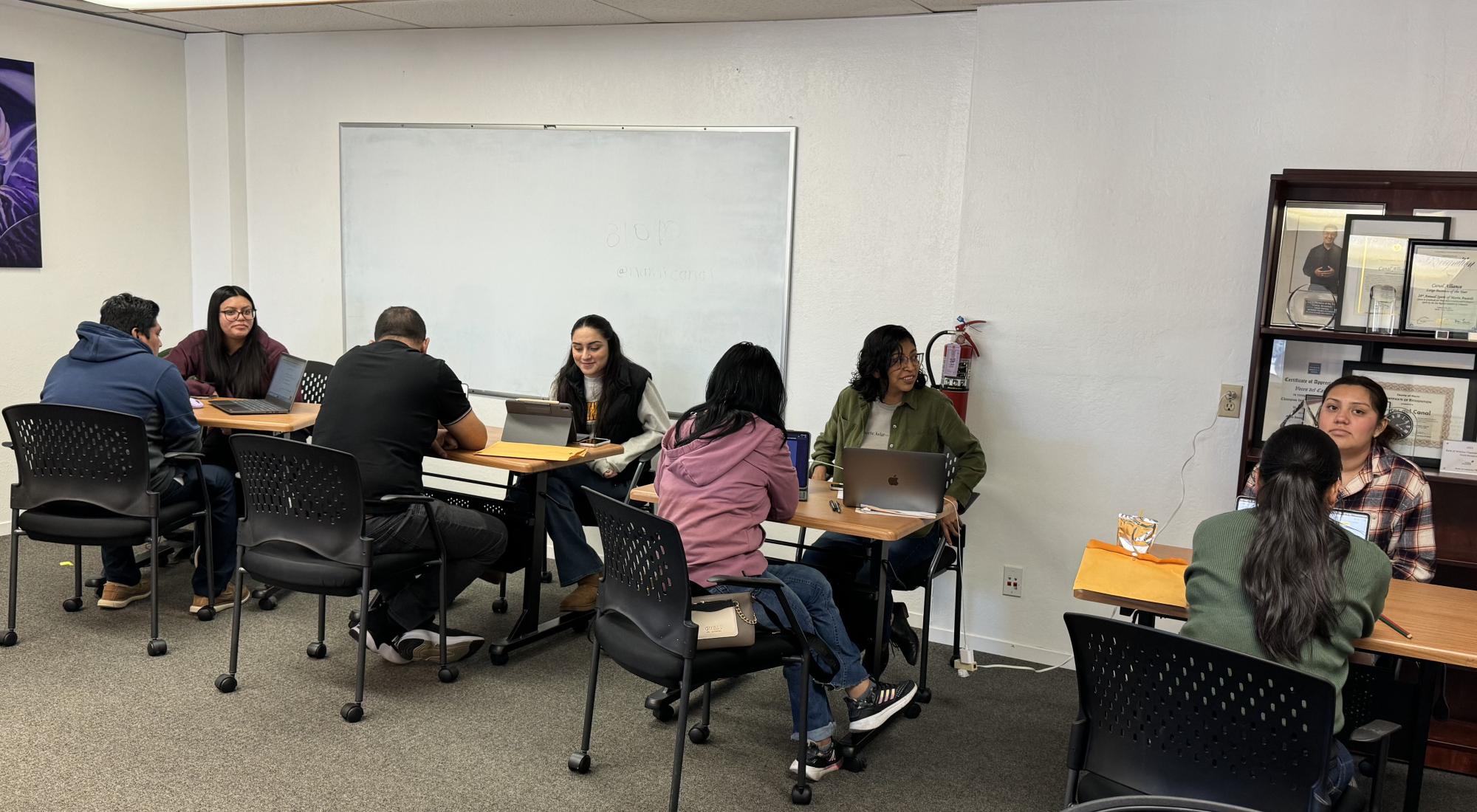 4 participant and student pairs study at desks with computers.