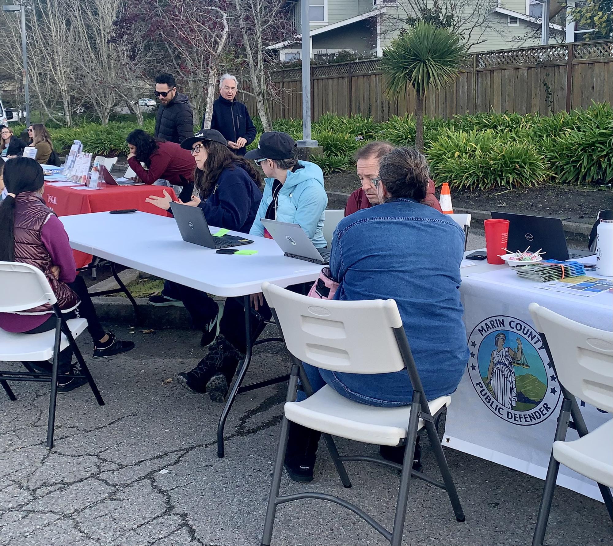 Staff speaking with clients at a Clean Slate event in Marin City.