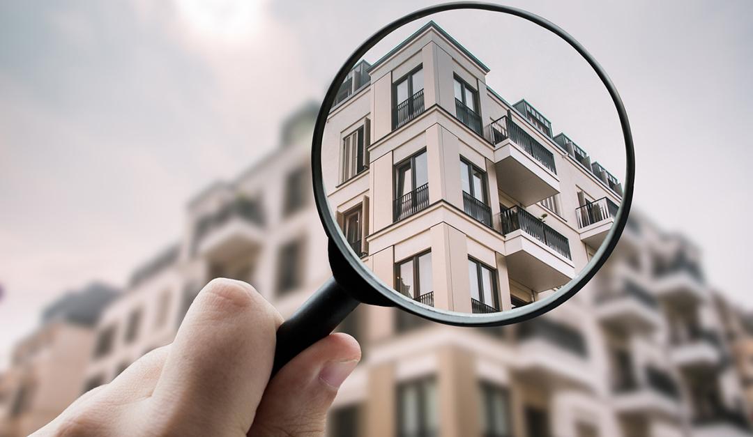 Magnifying glass focused on outside of apartment complex.