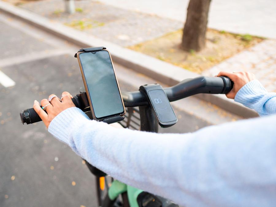 Phone is perched on bike handle bars.