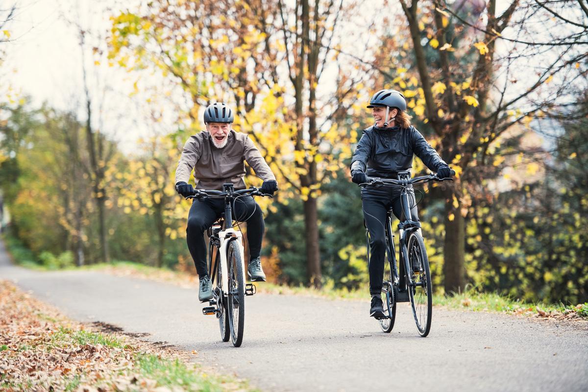 Two e-bike riders enjoying their ride through the park.
