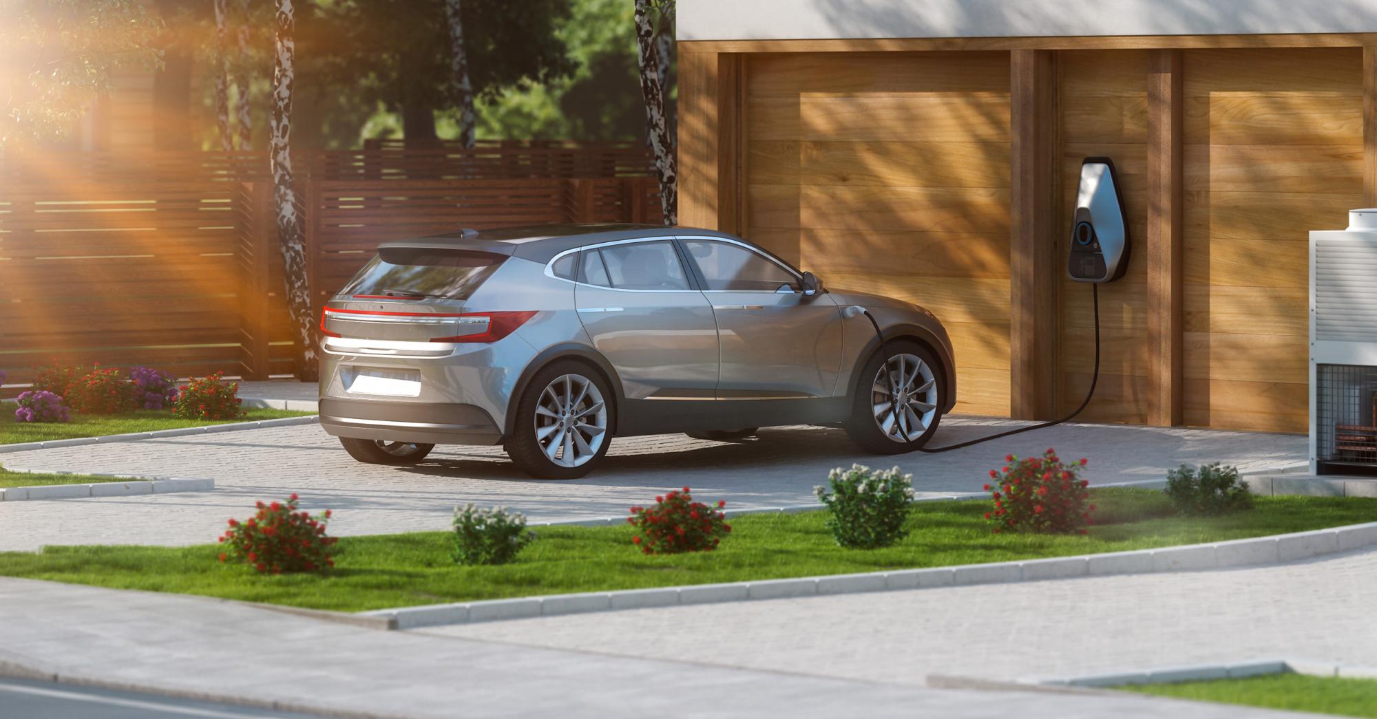 EV charges in front of garage.