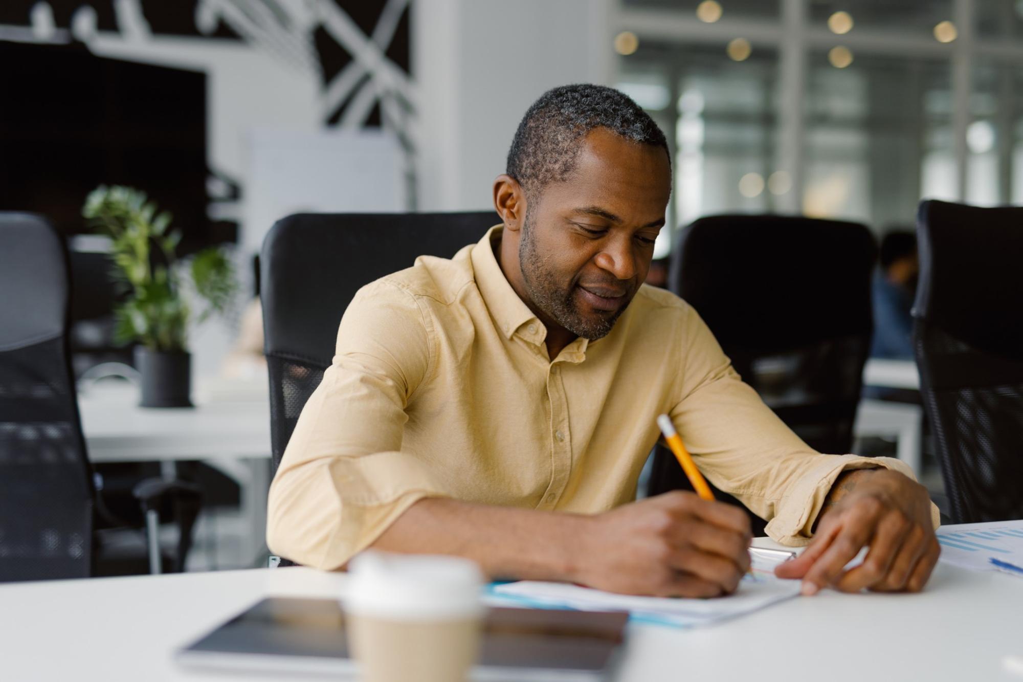 man working on documents
