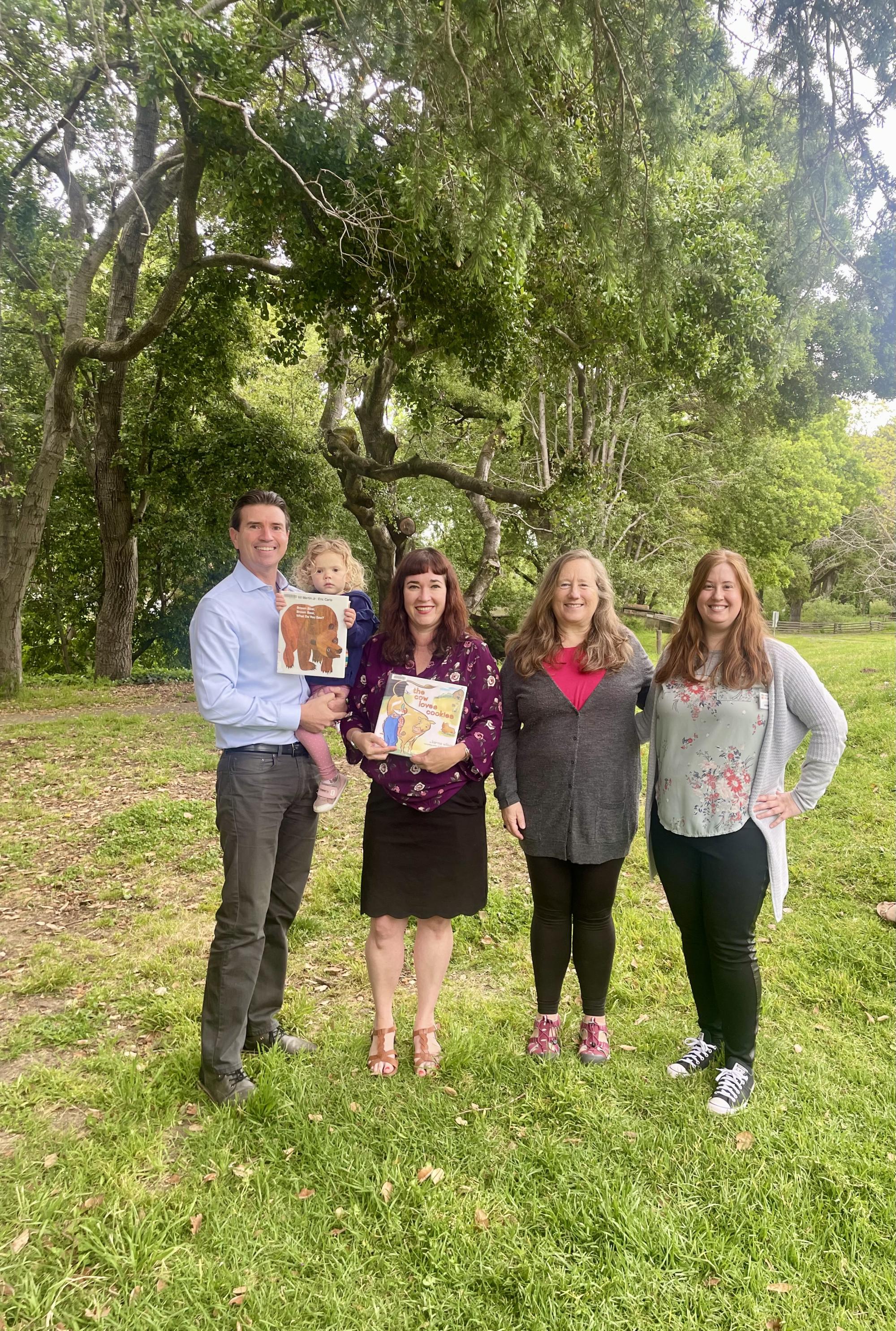 Eric with daughter and library team members at the Novato Library. 
