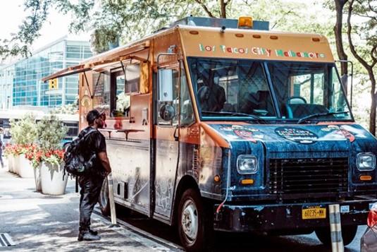 man purchasing food from a mobile food truck