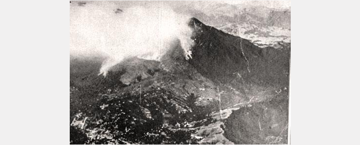 Mount Tamalpais with smoke billowing from one side. Black and white photo.