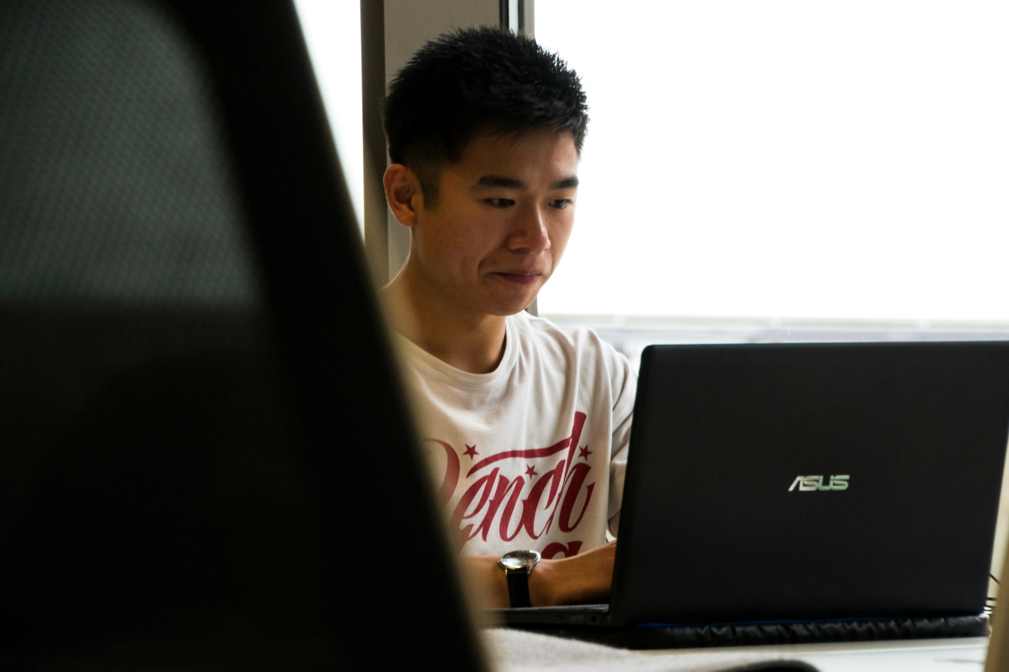 Person sitting at a computer, deep in thought.